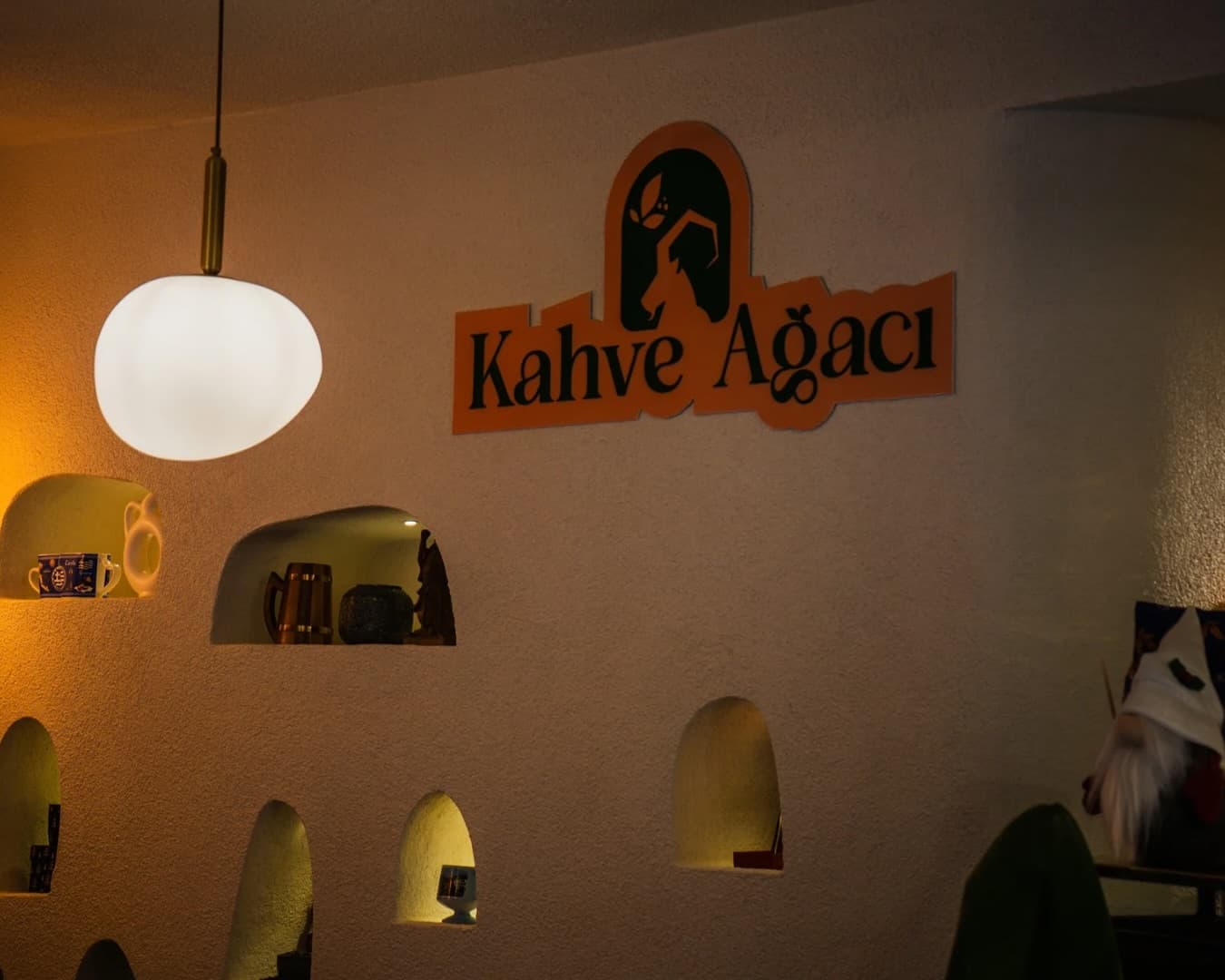 Kahve Ağacı duvar logosu ve sıcak aydınlatma